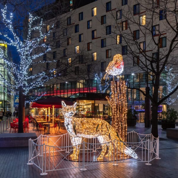 fox and robin christmas light sculpture with wrapped lit trees