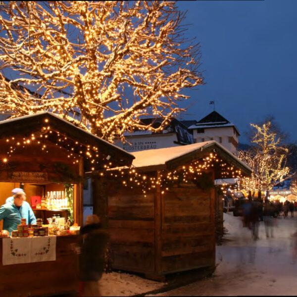 christmas market lighting wrapped trees in string lights ice lights