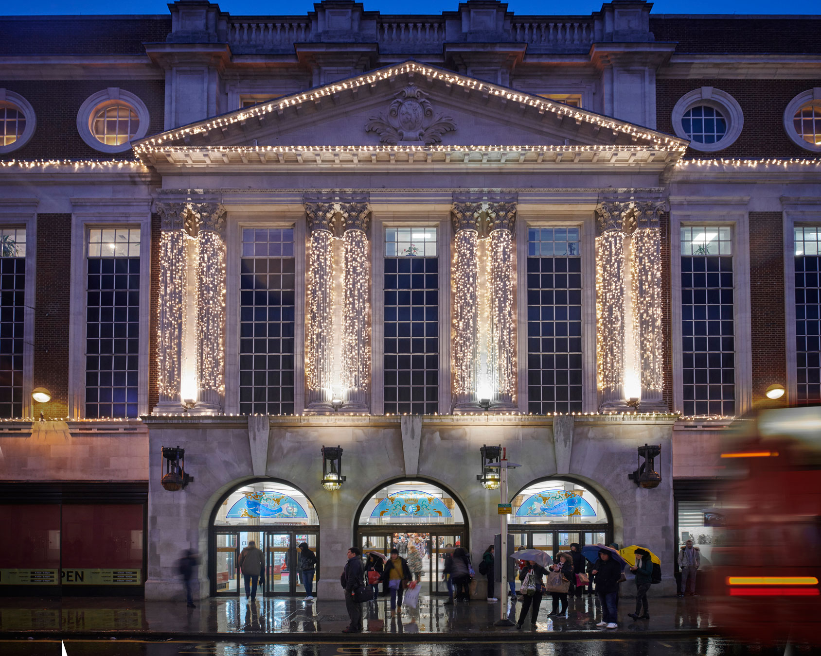 outdoor christmas building lights, wrapped around columns and architecture