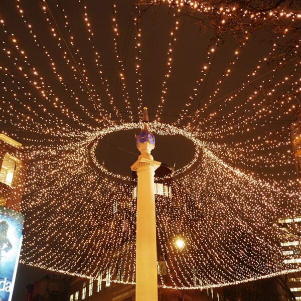String lights on monument at Seven dials