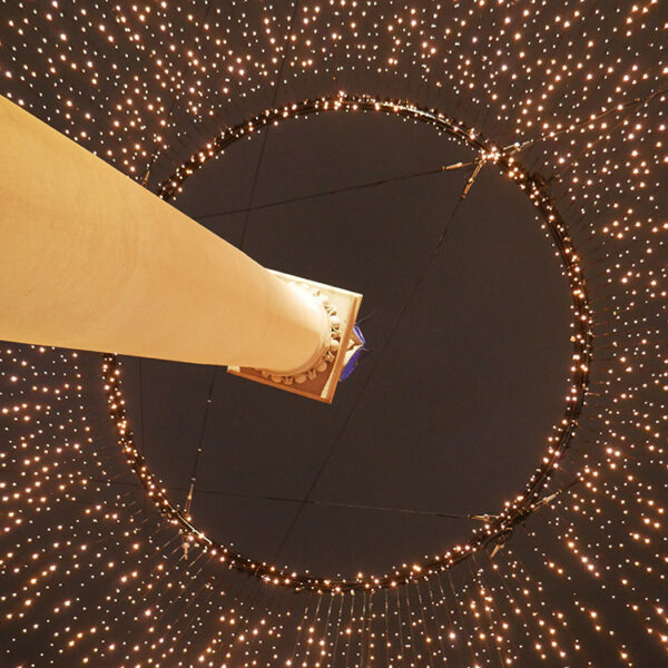String lights on monument at Seven dials