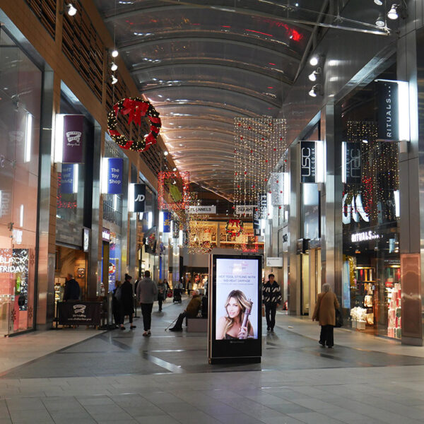 Shopping centre street with Christmas lights and decorations.