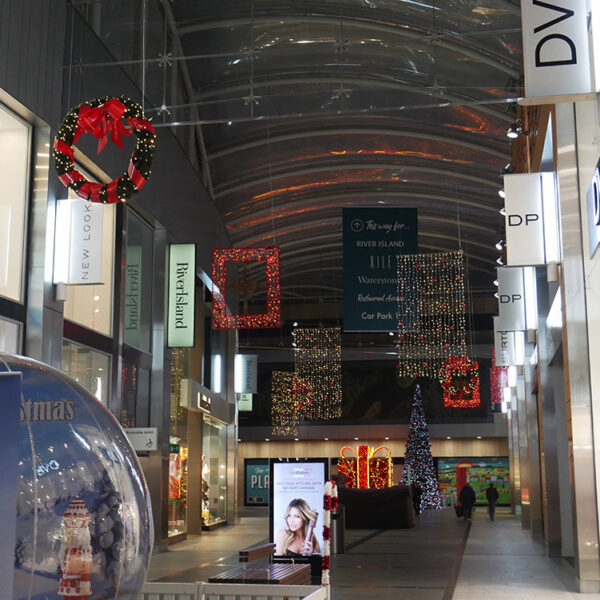 Shopping centre street with Christmas lights and decorations.