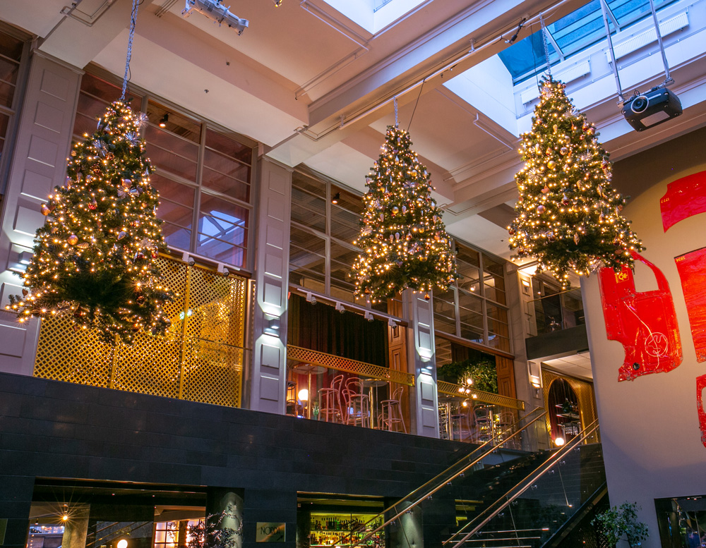 Christmas Trees suspended from ceiling in lobby